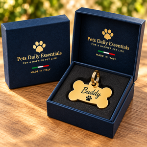 Illustrative Bone Solid Brass pet ID tag inside navy-and-gold Pets Daily Essentials box with Italian flag